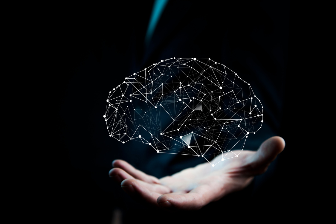 businessman hand holding brain in palm